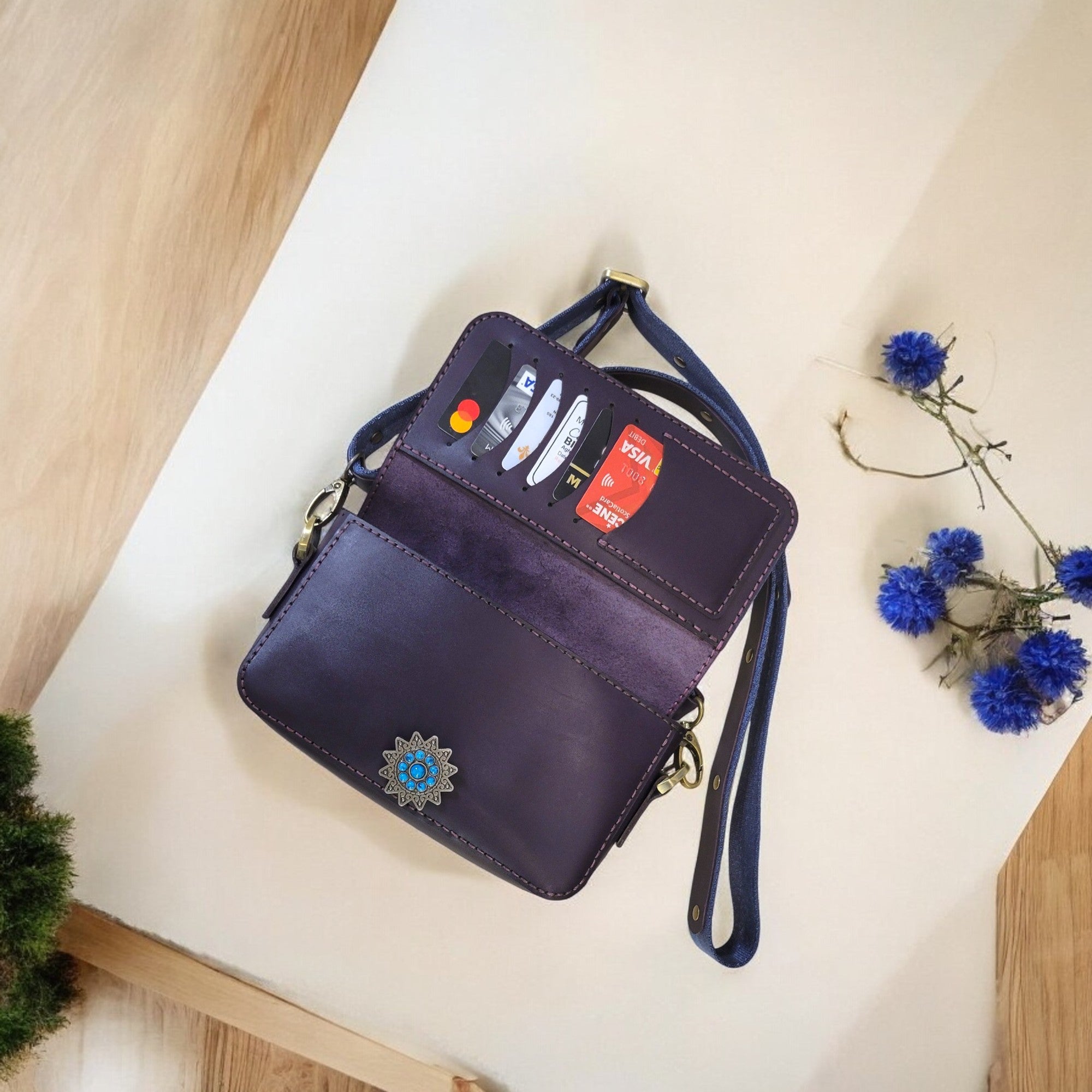 “HagorArts handmade leather bag featuring turquoise accent clasp and interior organizer.”